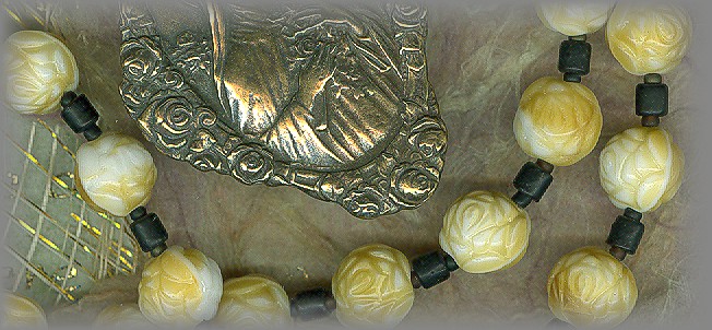 CHAPLETS: close up of antique beads and medal