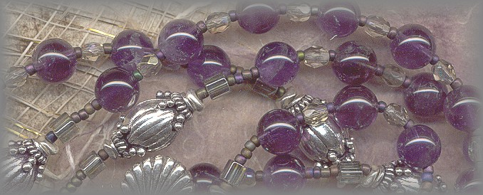 CATHOLIC ROSARY: closeup of amethyst beads and silver